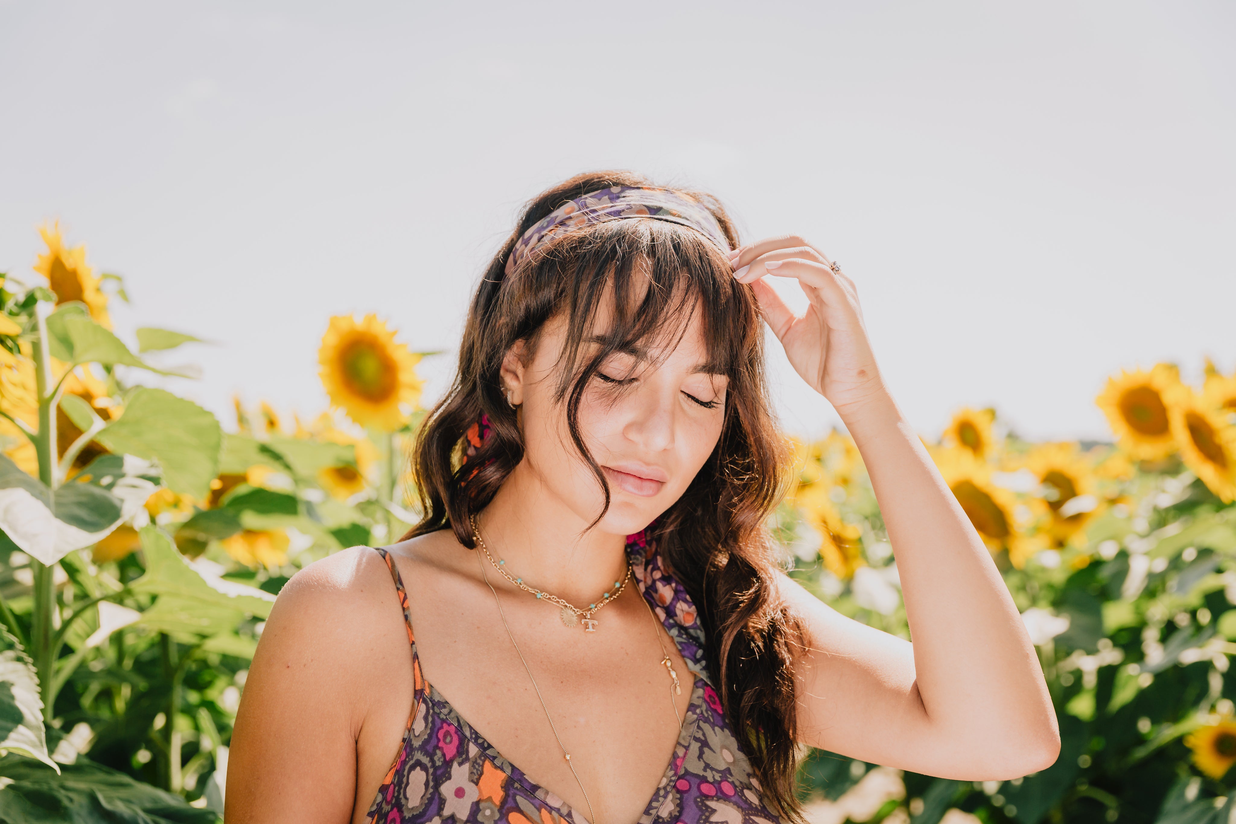 files/portrait-of-a-woman-with-her-eyes-closed-by-a-sunflower-field.jpg